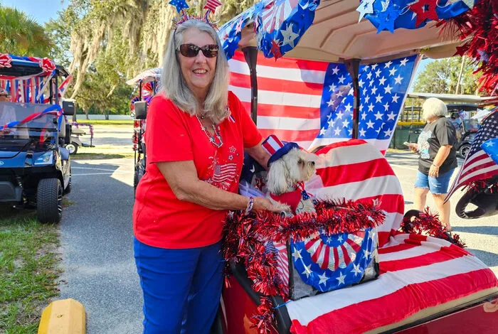 Resident with a decorated golf cart on the Fourth of July, Holiday RV