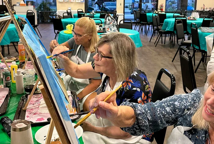 Residents at easels during a painting class, The Meadows
