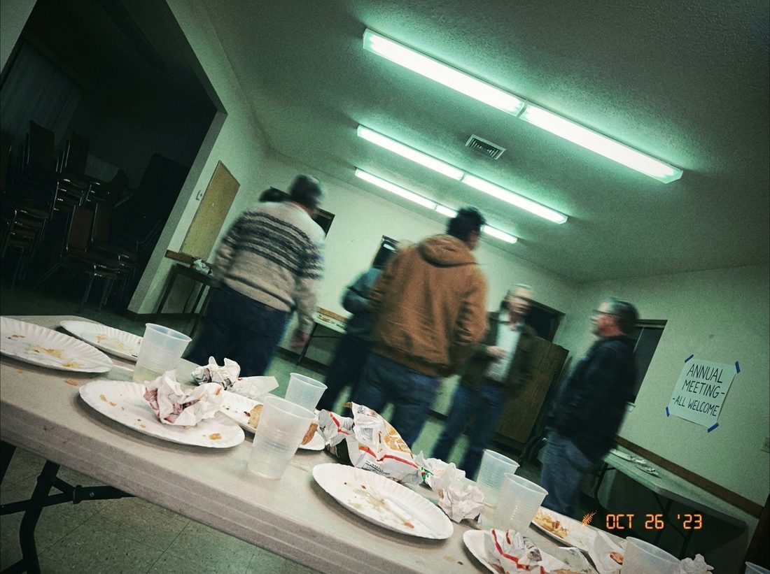 Harsh flash, tilted, cluttered event photo